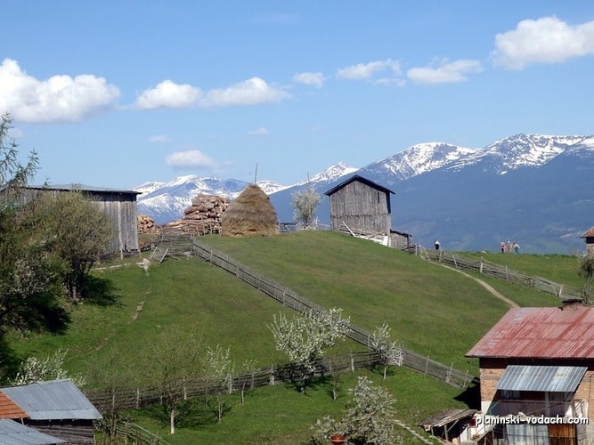 View to Bel Kamen Village and the southern slopes of Rila Mountains on the back View to Bel Kamen Village and the southern slopes of Rila Mountains on the back